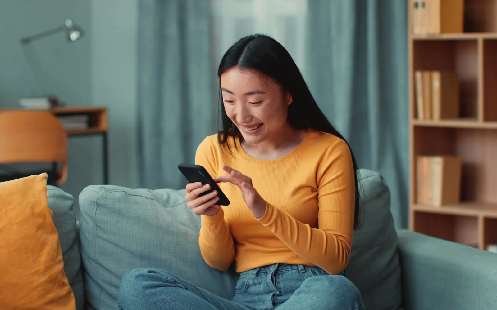 An artist laughing at a message from a returning client