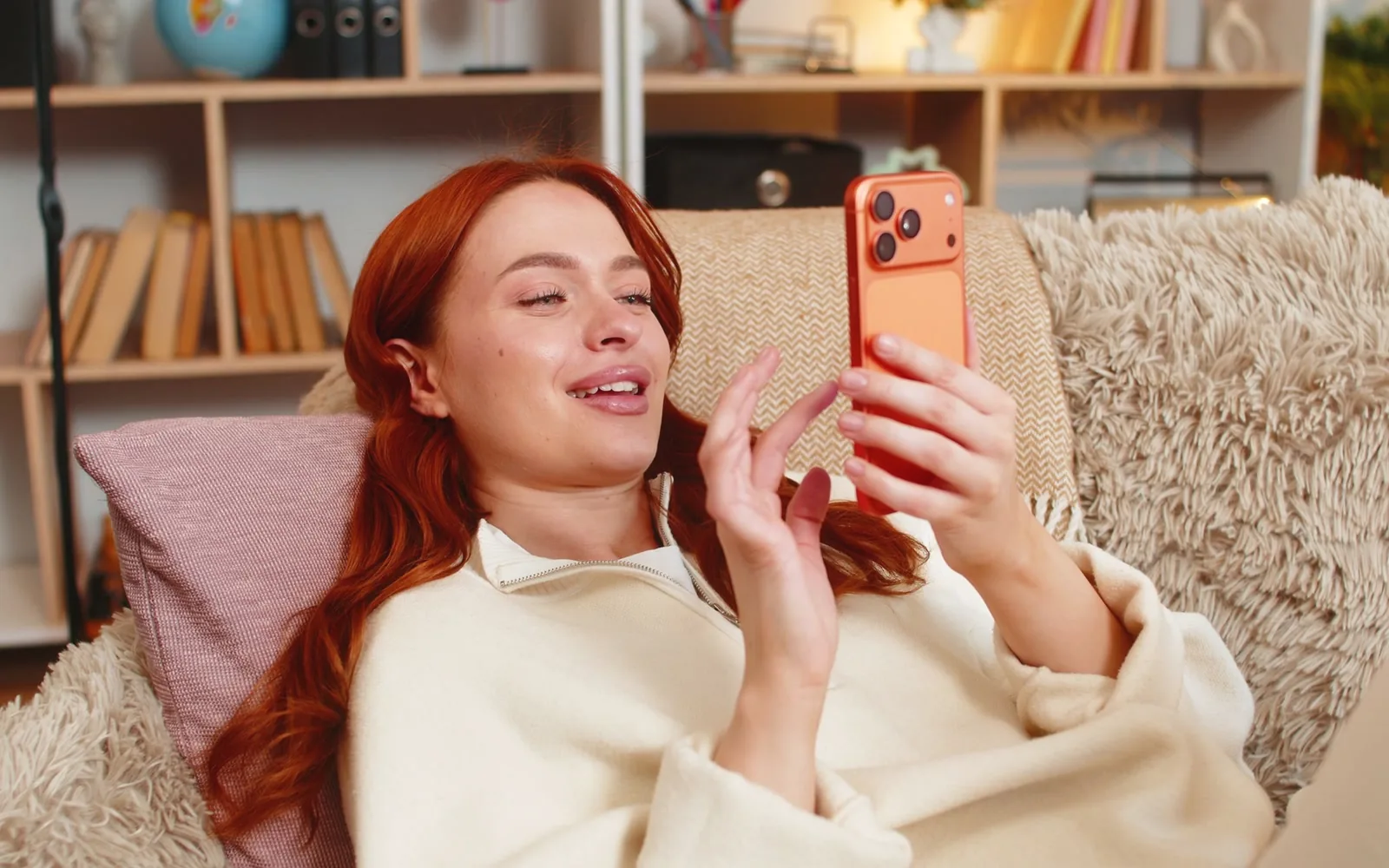 An artist smiling while reading a client enquiry on her phone