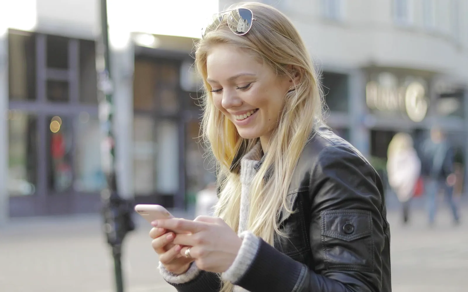 An artist checking her studio messages on her phone while out